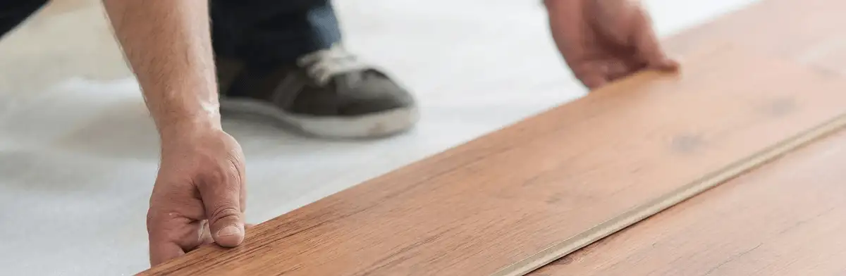 A professional installing laminate flooring in Ann Arbor, MI